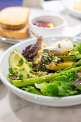 Superfood salad with avocado and poached egg