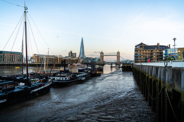 Fototapeta premium City skyline after sunset with the Shard and London Bridge across Thames river with night lights on in London, United Kingdom