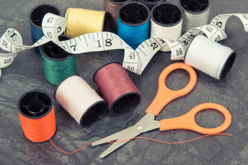 Accessories and tools for using in sewing. Spools of thread, scissors and centimeter