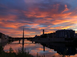 Colorful sunset with the clouds over the city