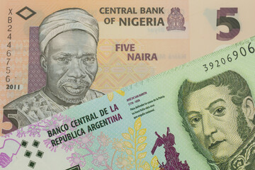 A macro image of a orange, plastic five naira note from Nigeria paired up with a colorful five peso note from Argentina.  Shot close up in macro.