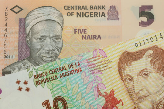 A macro image of a orange, plastic five naira note from Nigeria paired up with a colorful ten peso note from Argentina.  Shot close up in macro.