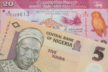 A macro image of a orange, plastic five naira note from Nigeria paired up with a pink and white twenty rupee bank note from Sri Lanka.  Shot close up in macro.