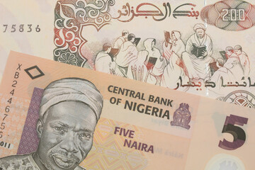 A macro image of a orange, plastic five naira note from Nigeria paired up with a beige 200 Algerian dinar bank note.  Shot close up in macro. - obrazy, fototapety, plakaty