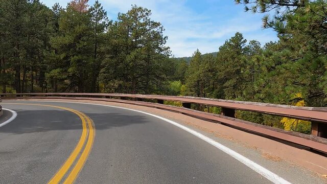 Custer South Dakota autumn curve scenic bridge POV. Black Hills of South Dakota. Mountain, valley, landscape scenic discovery. State Park with wildlife. Conservation and ecology area. Campgrounds.