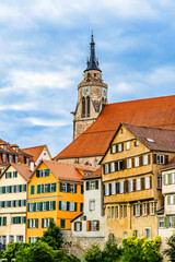 Medieval late gothic St. George's Collegiate Church (Stiftskirche) and colorful old buildings cityscape in the old town of Tübingen, Baden-Württemberg, Germany