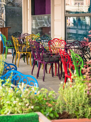 Empty outdoor terrase with colored chairs and tables in Bucharest
