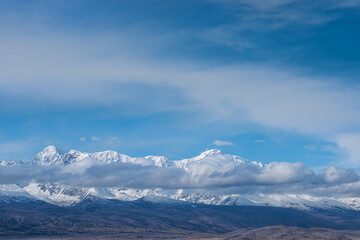 Fototapeta na wymiar panoramic view of picturesque snowy mountains tops on blue sky background