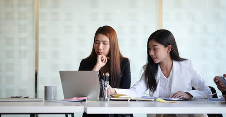 Business people discussing their project in meeting room at modern office.