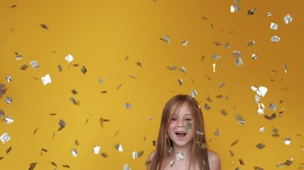 Happy birthday girl. Holiday joy. Fun celebration. Surprised amused kid enjoying party entertainment in confetti rain isolated on yellow background. - Powered by Adobe