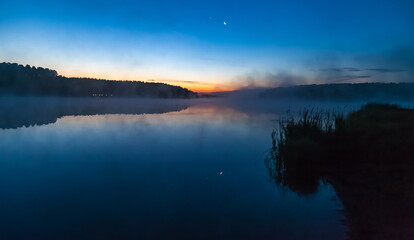 Mist over the lake dawn early morning in the summer