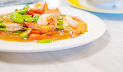 Stir Fried Sator beans with Shrimp on white plate.Thai food.  Copy space.