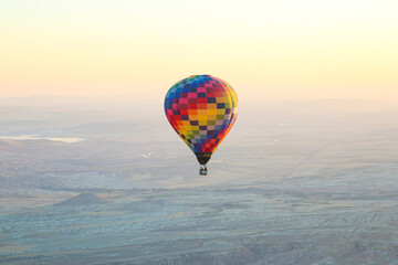 Beautiful colourful balloons flight in the morning in Cappadocia in Turkey. Amazing landscape background.