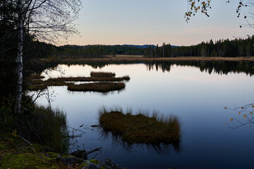 Triungsvanna, Oslomarka, Norway. Nature reserve. Shot in golden/blue hour in october.  A crisp and cold evening in Nordmarka. This lake and forest is only a few kilometers from down town city of oslo.