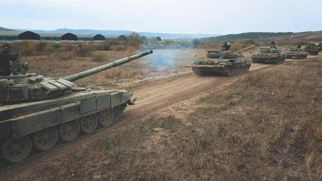 Soldiers and transport vehicles on muddy road aerial