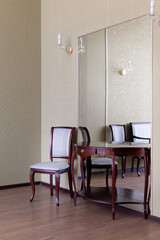 room interior with green walls. rare chairs and table in the interior