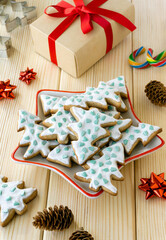 Christmas and new year baking. Homemade gingerbread cookies in the shape of trees in plate on wooden background