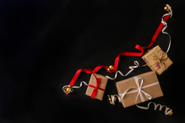 gifts for Christmas, wrapped in wrapping paper and tied with a ribbon, next to the Golden Christmas...