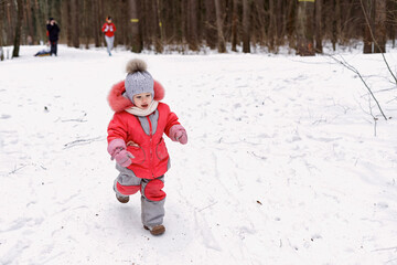 happy baby in winter forest. fun in the fresh air for a Christmas mood