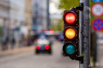 a city crossing with a semaphore, red and orange light in semaphore