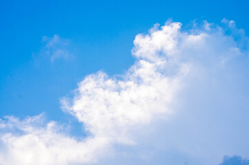 huge clouds float on the blue sky.	