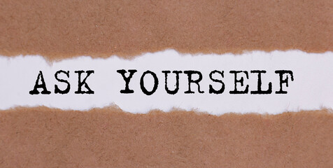 ASK YOURSELF written under torn paper on white background