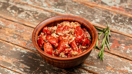 Bowl of sun dried tomatoes garlic, oregano, olive oil, wooden textured background. space for text. top view. Long banner format