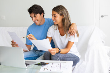 Young happy people looking at laptop, building family financial plan, meal planning for healthy style, wedding ideas, ordering gifts, free online courses to get diploma. Man working in home office