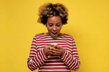 Young african woman girl using mobile phone, typing sms message