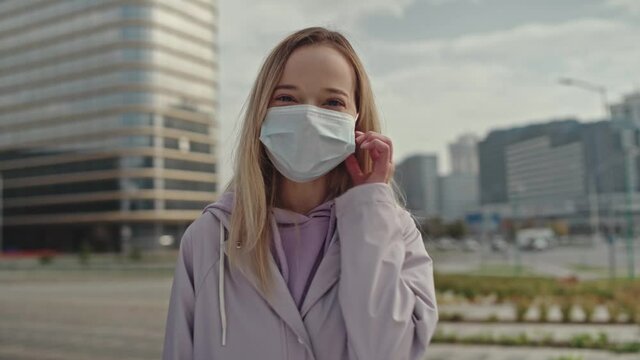 Completion of quarantine. Young happy girl blogger, take off medical mask, looking talking to camera recording blog vlog outdoors, speaking to webcam making call online dating chat, webcamera view