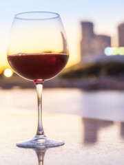 glass of wine  on the background of the evening city. Date overlooking the city. Panoramic restaurant. cocktail on the background of skyscrapers. Romantic atmosphere