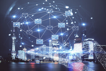 Double exposure of envelop hologram flying from gadget and city view background. Concept e-mail.
