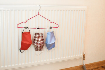 Obraz na płótnie Canvas The cloth mask hanging.Hand made cotton cloth face mask are drying. Home made reusable face mask after washing. 