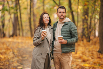 Fototapeta premium Happy family walking in autumn park on sunny fall day