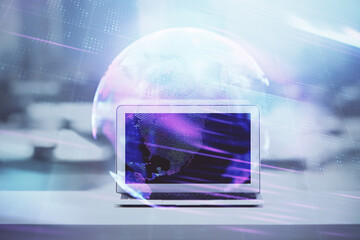 Computer on desktop in office with technology theme hologram. Double exposure. Tech concept.