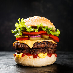 Fresh tasty double hamburger on black background.
