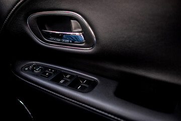 Detail on buttons controlling the windows in a car.
