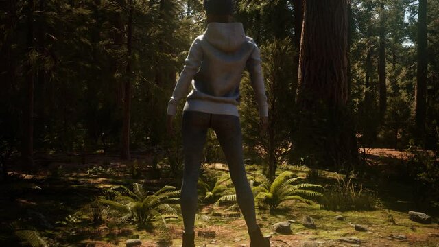 Woman in Yosimite national park near sequoia in California, USA