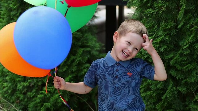 Laughing boy with balloons in the Park