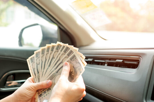Car and money. 10000 Japanese yen, Stack of Japanese currency yen bank., Concept of buying new car. Background. Copy space.