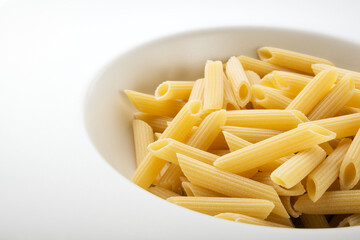 Durum wheat pasta, Penne in a gourmet deep plate, closeup.