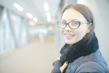 adult model girl in a coat on a winter walk in the city / Christmas vacation city tour