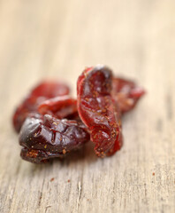 Dried cranberries on wood background