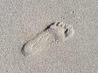 Footprint of a man on a sandy seashore