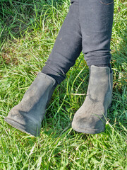 Woman horse rider sit with crossed legs in paddock