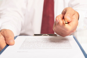 businessman giving a pen to sign a contract, white and red colors
