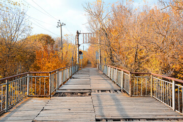 Autumn - Old wooden bridge in the autumn park on a sunny day