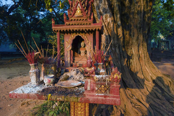 banyan tree and spirit house in the courtyard of the Bakong temple, Siem Reap in Cambodia