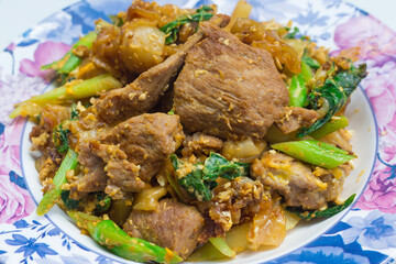 Thai stir fried noodles (Pad See Ew) is a popular Thai street food of Thailand. Pad See Ew is traditionally made with Sen Yai, (which are wide, thin fresh rice noodles) combined with egg, pork, kale