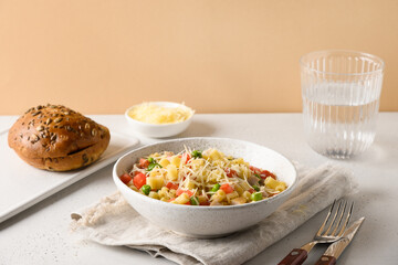 Salad with ditalini pasta, peas, vegan sausage on modern white table. Close up. Tasty dinner.